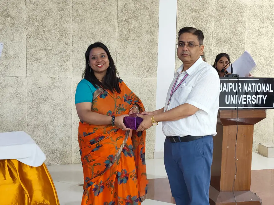 Felicitation at the podium. Jaipur National University, Jaipur, Rajasthan.